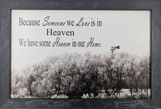 Framed picture with a black and white landscape and text on a white wall.