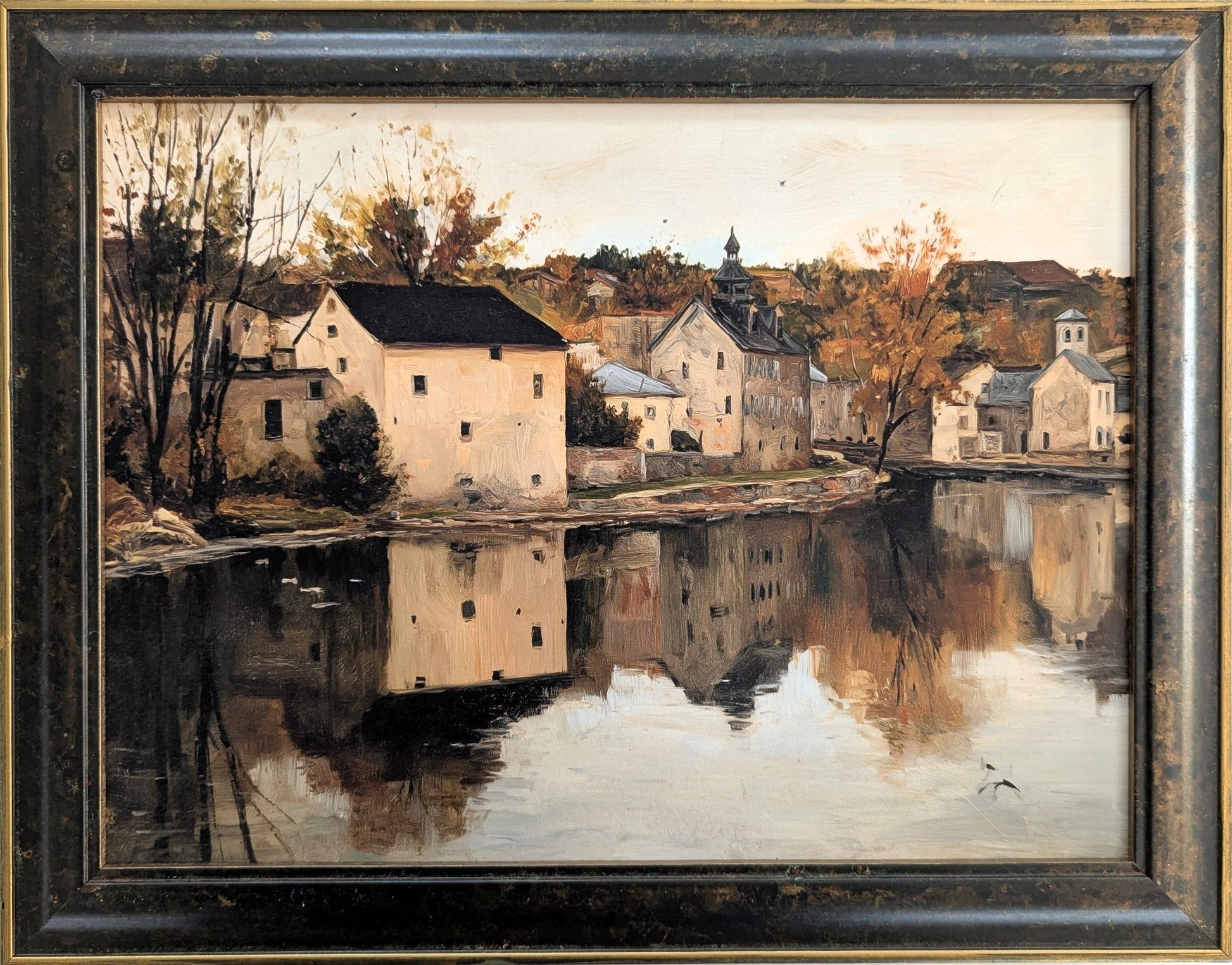 Painting of a village by a lake with reflective water and autumn trees.