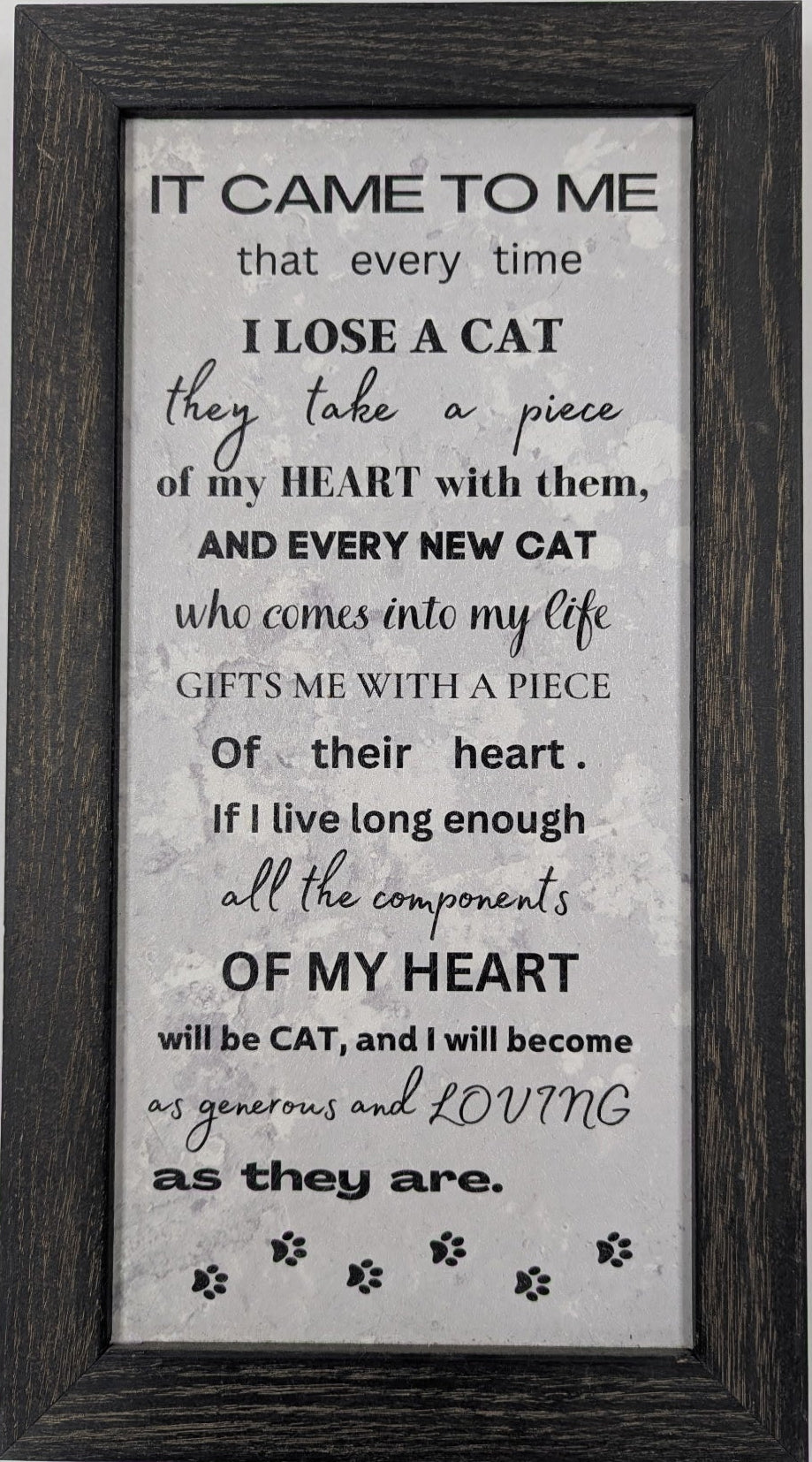 Framed text art on a gray background with a black frame