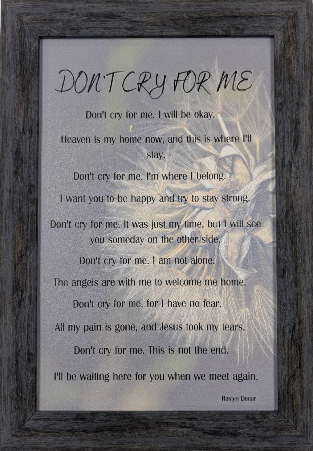 Framed artwork with text and a silhouette of a person against a gray background