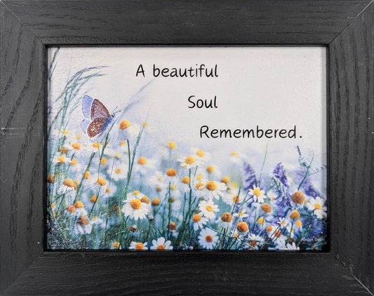 Framed artwork with flowers and butterfly on a white background