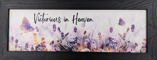 Framed artwork with floral design and 'Victorious in Heaven' text on a white background