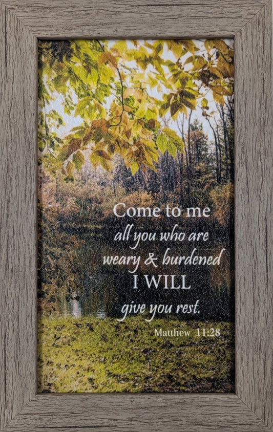Framed print with nature scene and inspirational quote on a white wall
