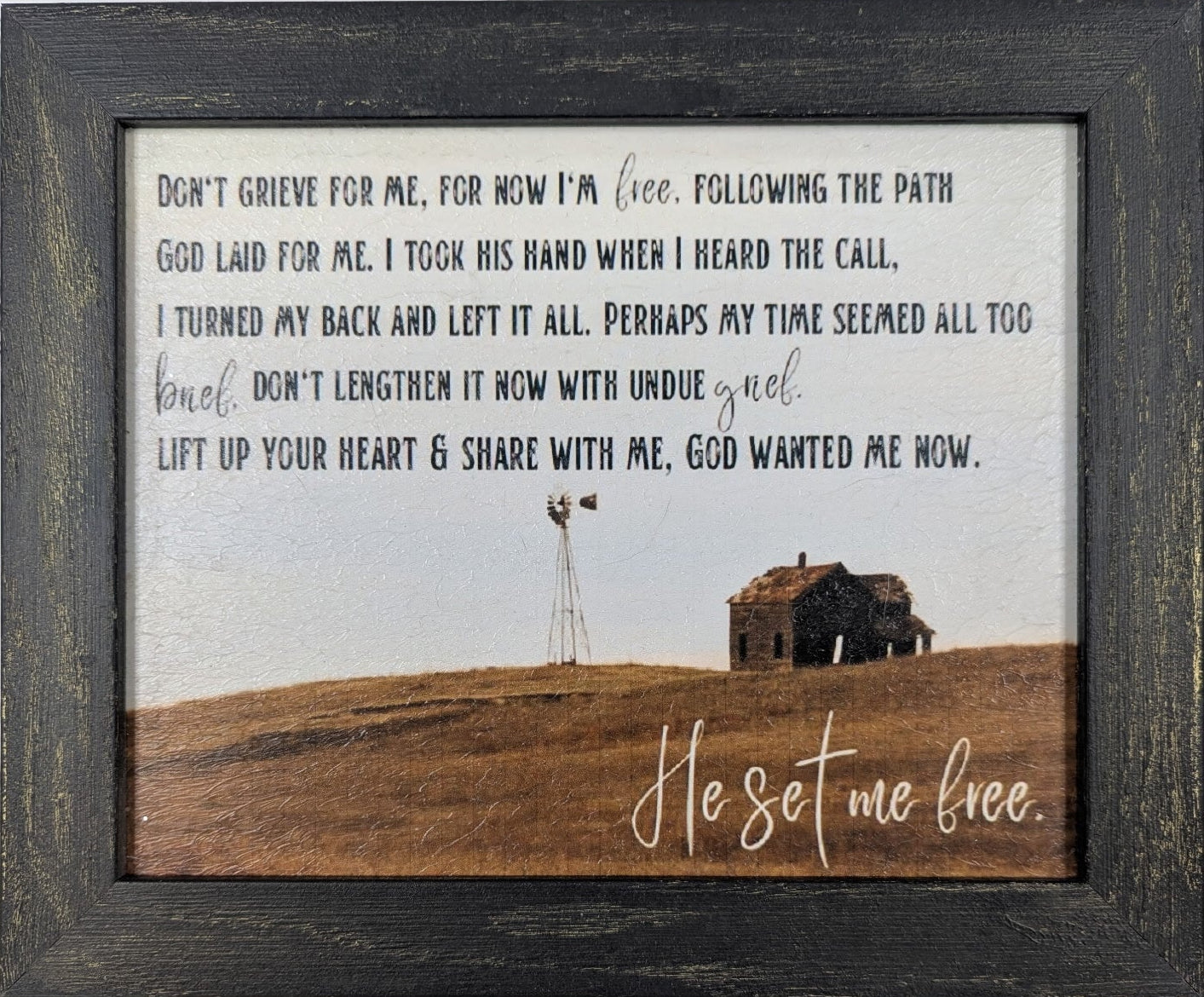 Framed print with a scenic landscape and inspirational text on a white background