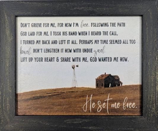 Framed print with a scenic landscape and inspirational text on a white background