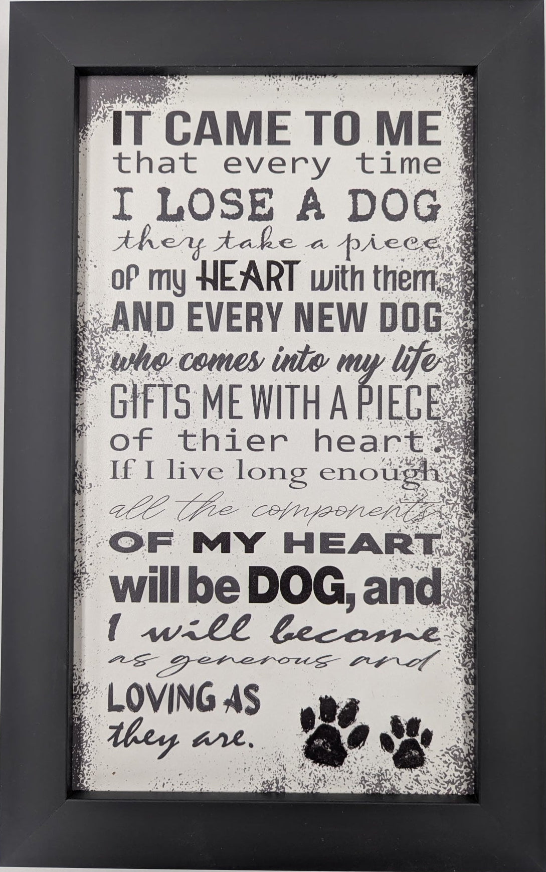 Framed text print with a quote about dogs on a light gray background