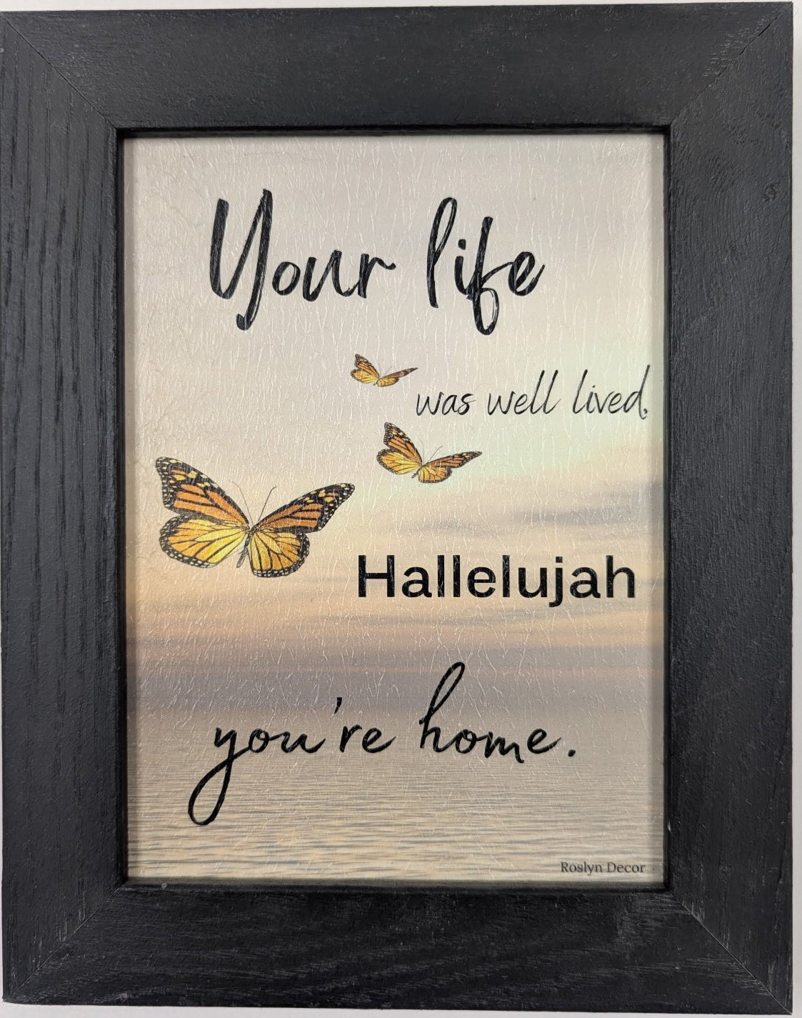 Framed print with butterflies and inspirational text on a light background