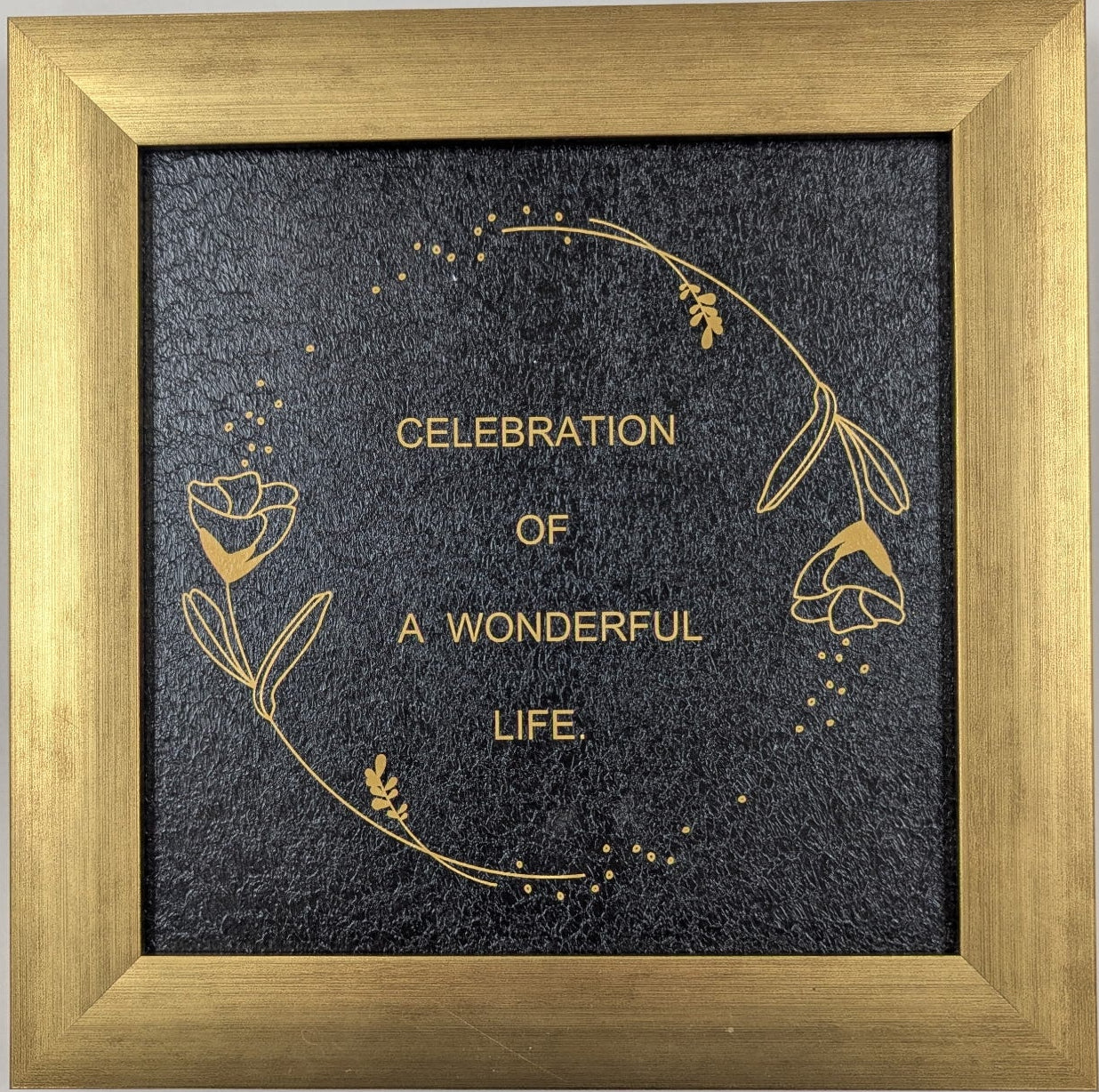 Framed artwork with 'Celebration of a Wonderful Life' text on a gray background