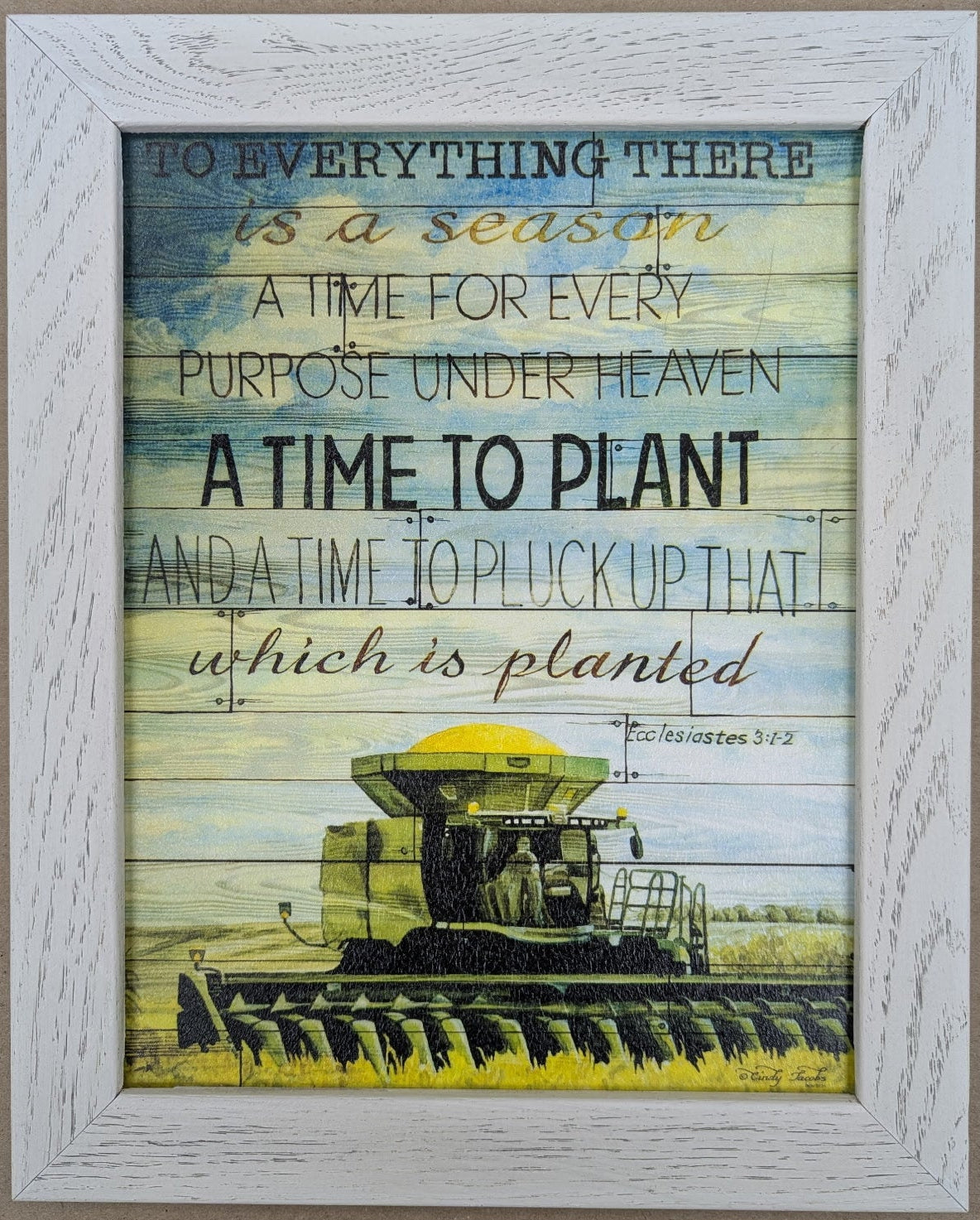Framed print with a harvester illustration and inspirational text on a beige background