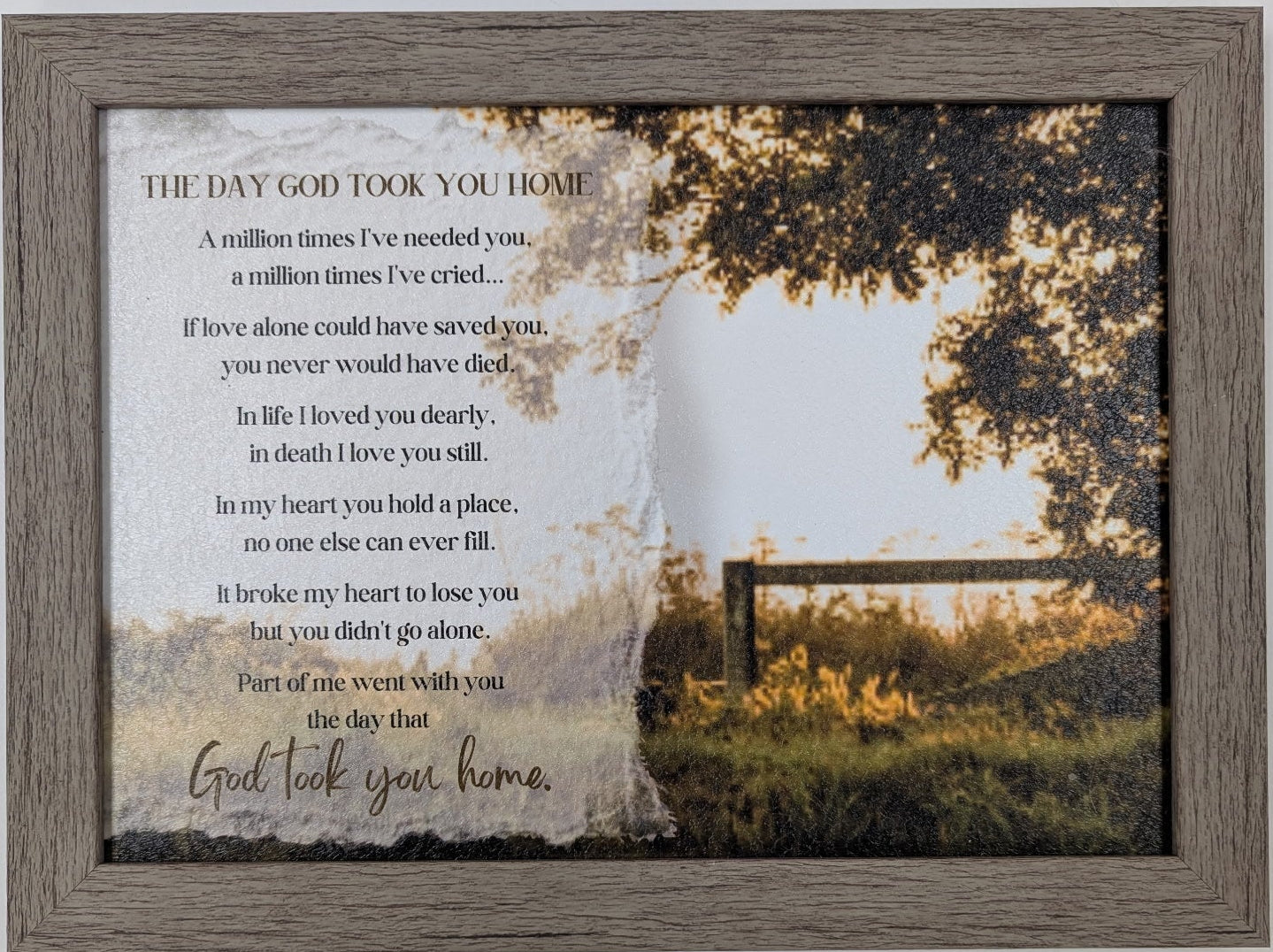 Framed artwork with a landscape scene and text on a white wall