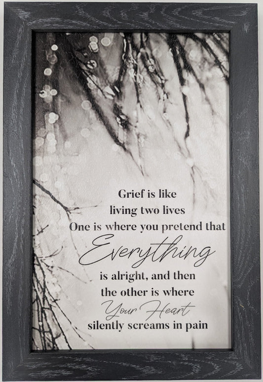 Framed print with a quote about grief on a marble background