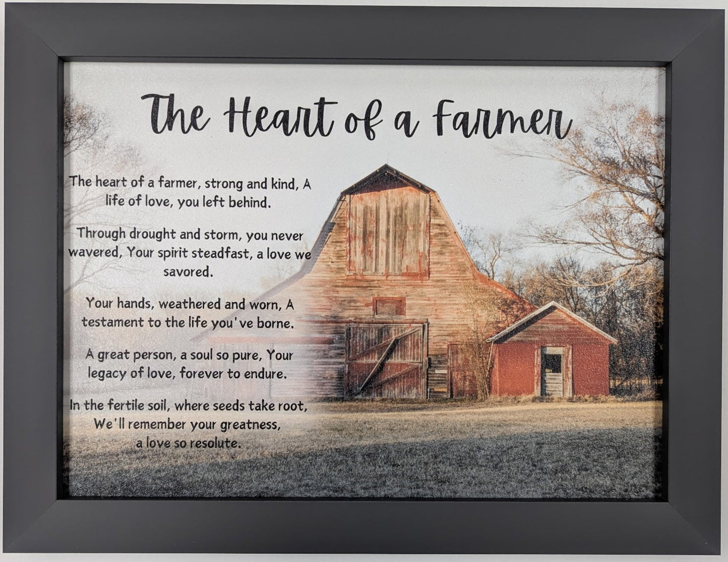 Framed picture of a barn with text about the 'Heart of a Farmer' on a light gray background