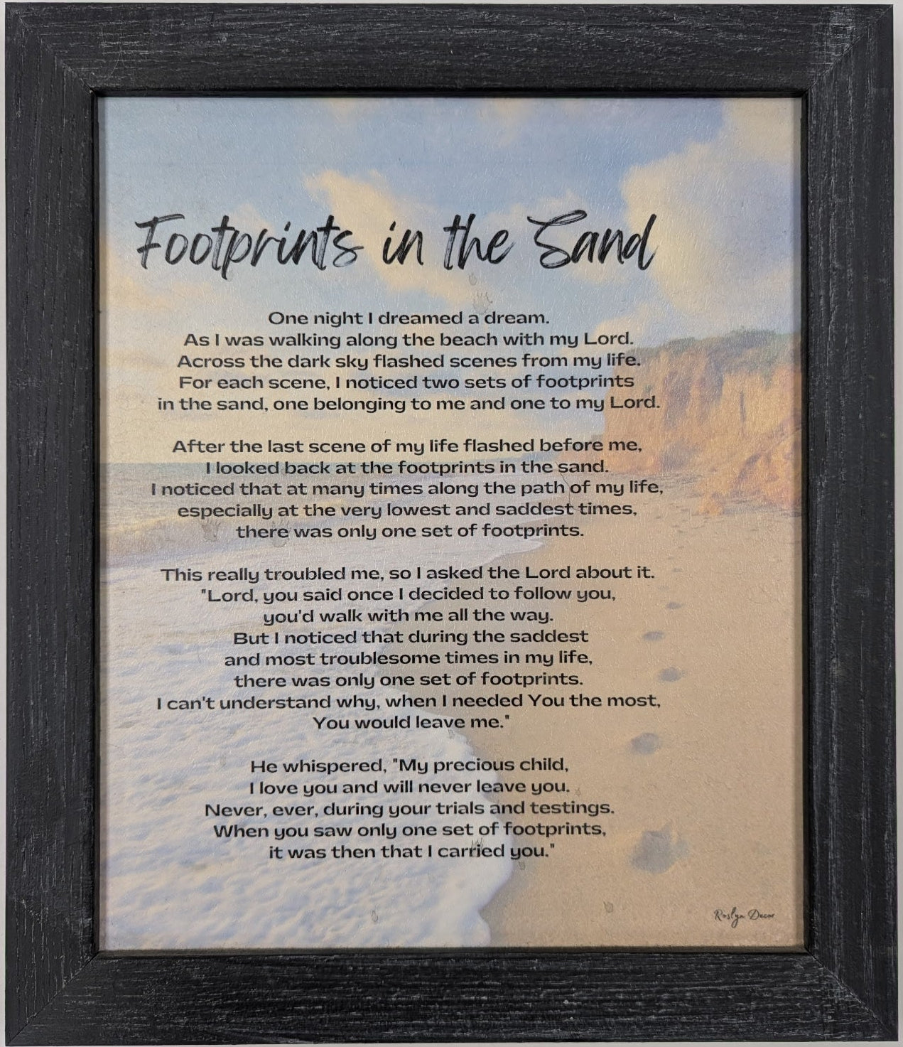 Framed print of 'Footprints in the Sand' poem with a scenic background
