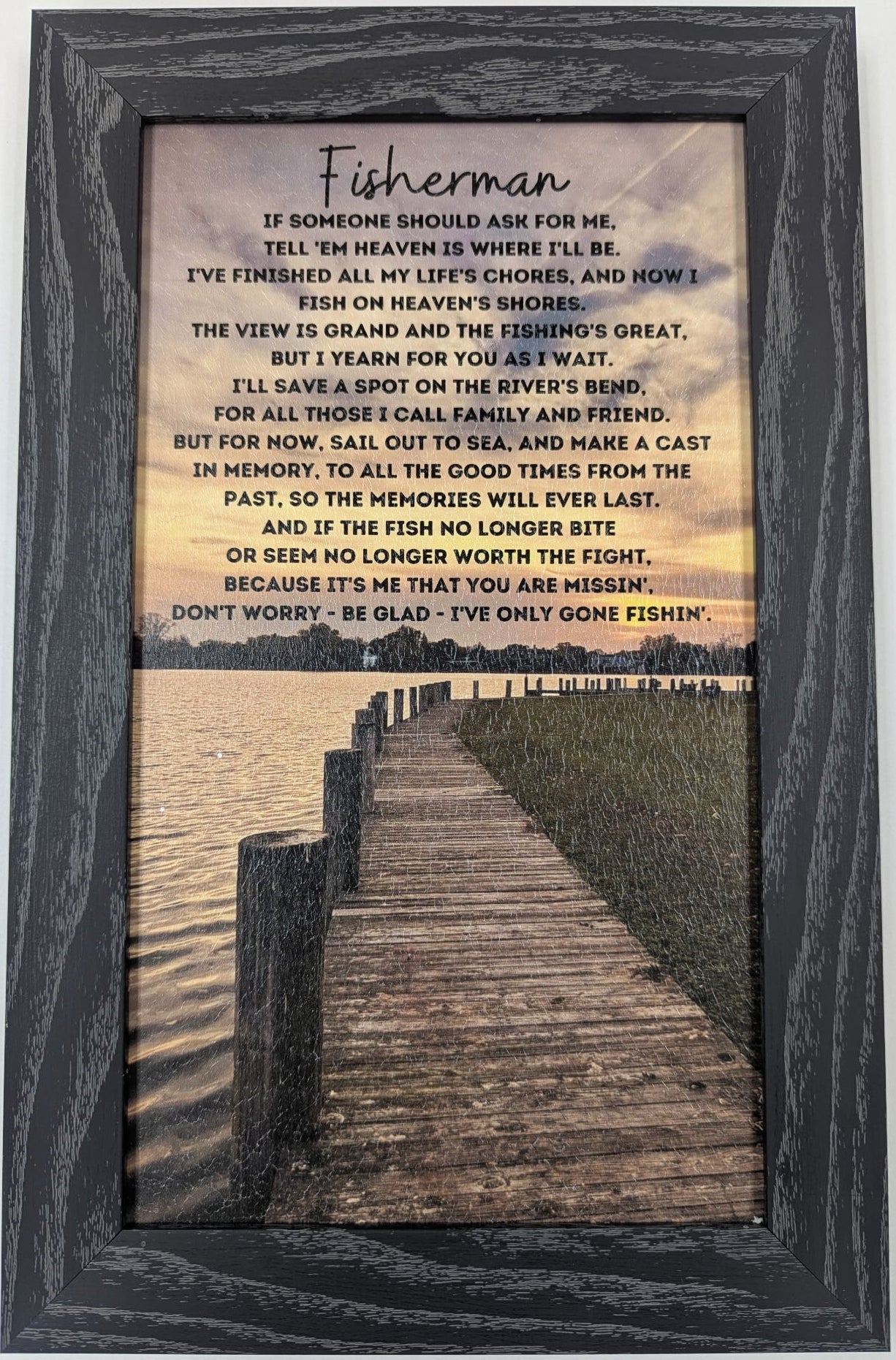 Framed artwork with a poem titled 'Fisherman' and a scenic view of a dock.