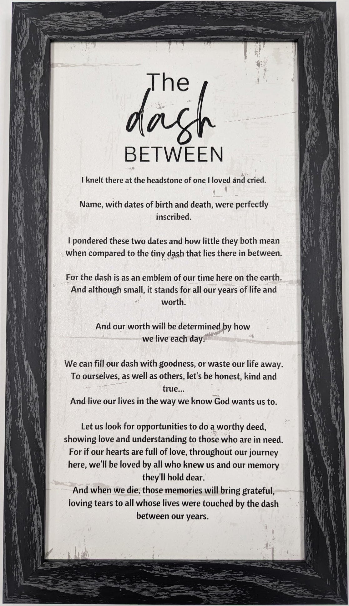 Framed print with 'The Dash Between' poem on a white background