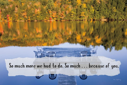 Reflective lake with dock and autumn trees, featuring a quote.