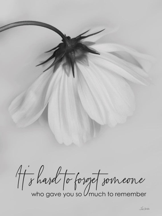 Black and white flower with a quote about remembering someone on a light gray background